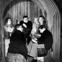 A family huddle in their corrugated iron Anderson shelter in London in 1940