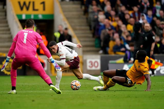 Manchester City's Phil Foden (centre) has an attempt at goal