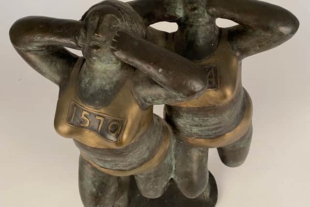 A  polished bronze by Geraldine Knight (1932-2008) titled Two Runners, estimated at £800-£1,200.