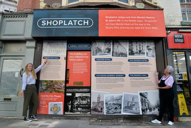 Maggie Love, a local historian who curated the panel, and Emma Molyneux with the window display