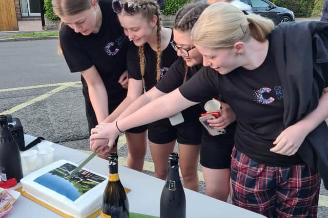 The teens were welcomed over the finish line by a group of family, friends and school staff