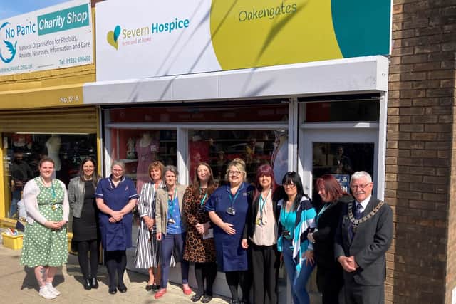 Hospice staff, volunteers and supporters celebrate the opening of the new shop