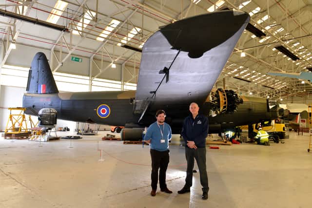 Curator Tom Hopkins (left), conservation centre manager Darren Priday and the Wellington bomber