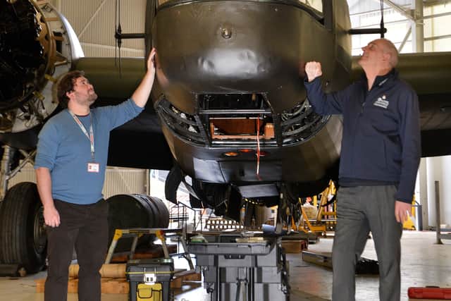 Curator Tom Hopkins (left), conservation centre manager Darren Priday and the Wellington bomber