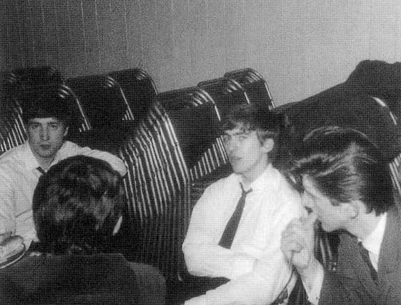 John, George, and Roger – with the Music Hall's chairs stacked up in the background.