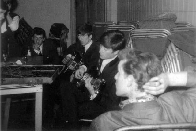 John and George strum away, watched by Roger and, foreground, Andre Wheeldon