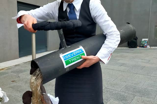 A protestor 'dumping raw sewage' outside the Severn Trent HQ
