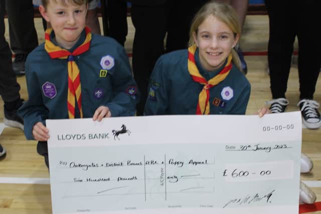 Finn Godwin and Isla Franks with the cheque.