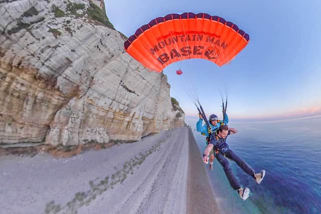 The pair in the air after jumping from the cliff 
