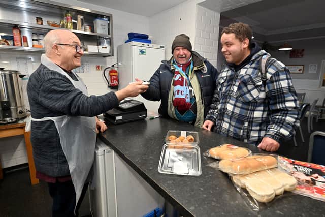 Arthur Shepherd hands over a bowl of soup to visitors Kevin Mitchell and Jonathan Wootton