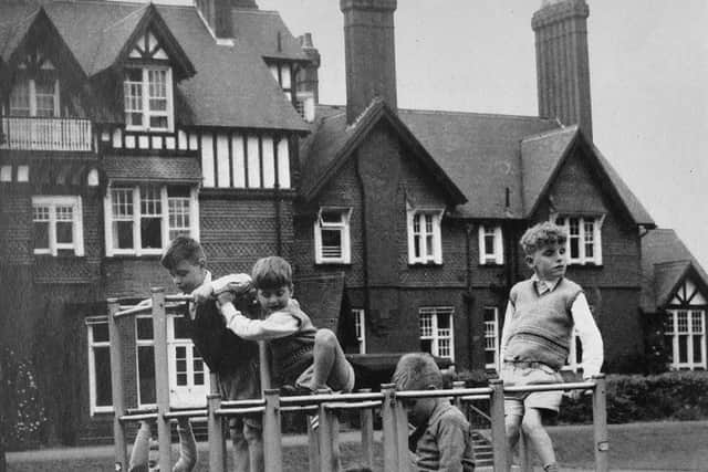 Children get to grips with a climbing frame in the grounds.