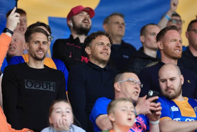 Former Shrewsbury Town players David Edwards, Sam Aiston and Gavin Cowan watch the game.