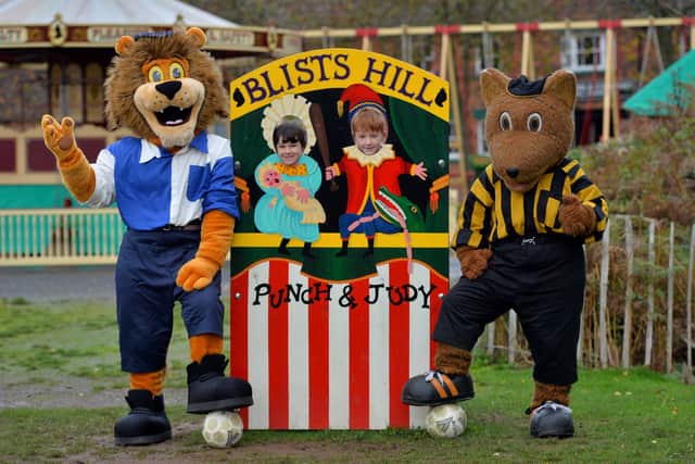 Wolves mascot Wolfie and Shrewsbury’s Lion show off the historic kits with Christ Church CE School pupils Frankie Finley, six, and Arna Wilkin, seven