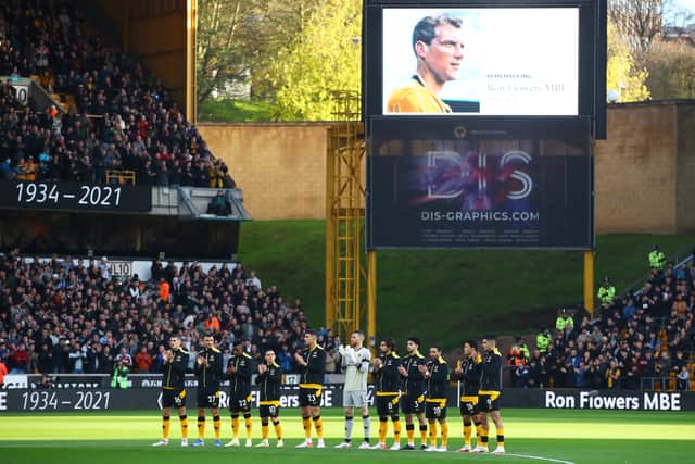 Players, fans and officials observe a minute of applause in tribute to former Wolverhampton Wanderers player Ron Flowers