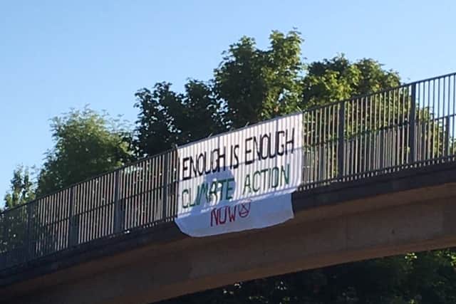 Protesters with bannisters over the M54