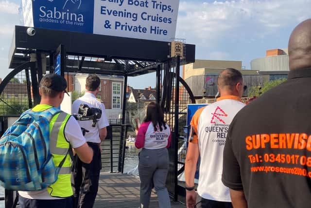 The baton is carried on board The Sabrina on its way to Pengwern Boathouse where was being rowed across the Severn and delivered to the Quarry. Photo: Shropshire Council.