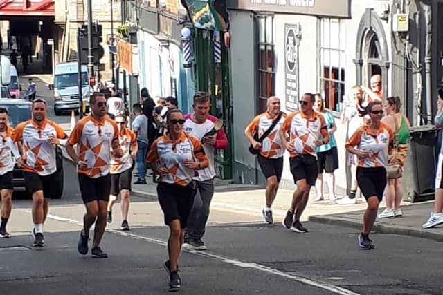 The Queen's Baton is carried along Castle Gates in Shrewsury. Photo: @ShrewsburyCops