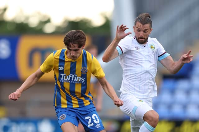 Tom Bayliss of Shrewsbury Town and Jay Rodriguez of Burnley (AMA)