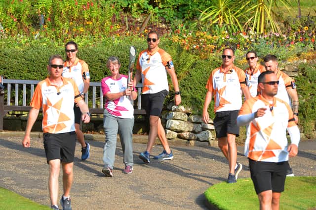 Baton-bearer Sally Johnson carries the Baton through The Dingle