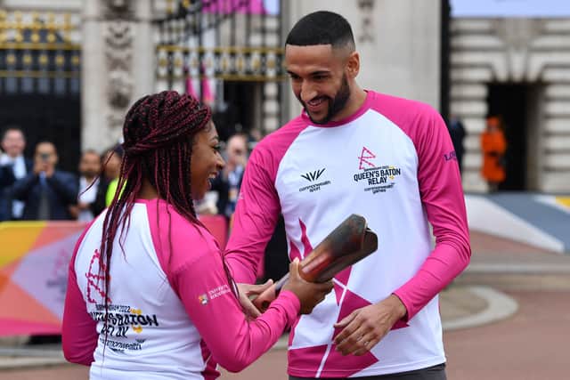 Kadeena Cox OBE passes the Baton to Declan James at the launch of the Birmingham 2022 Queen's Baton Relay on October 7 2021