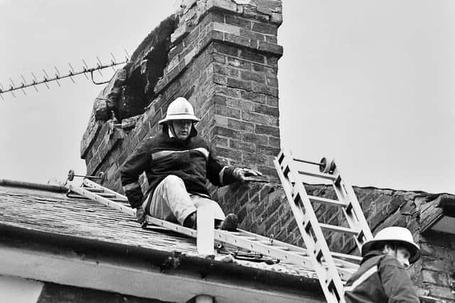 Firefighters making safe a damaged chimney in Shrewsbury in 1990