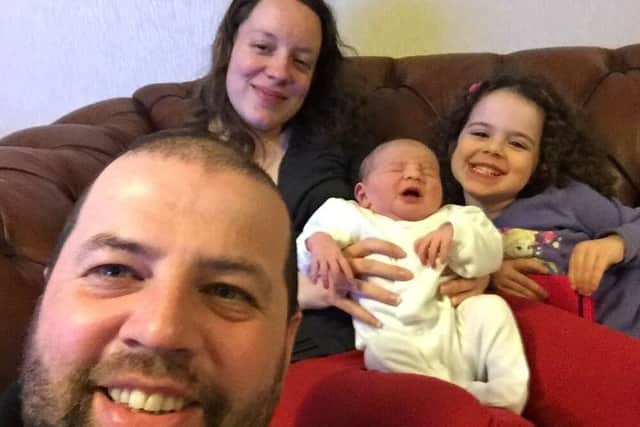 Pippa Griffiths being held by her mother Kayleigh and sister Brooke, with father Colin