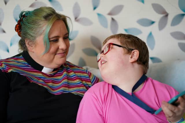 Rev Charlotte Cheshire at her home in Newport, with her son Adam.