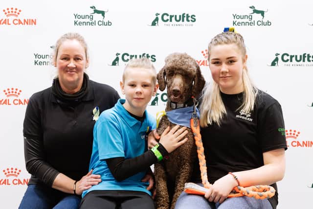 Vicky, Ewan and Morgan Looker relax with Rolly after the Labradoodle took on the Agility course
