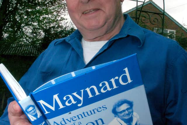 Maynard Davies with his book.