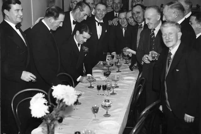 Gordon writes a note or perhaps his autograph at a special dinner for Shropshire sportsmen held at the Forest Glen at the foot of The Wrekin in December 1949.