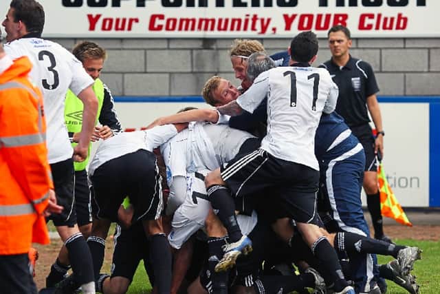 Phil Trainer is mobbed after he wonthe Conference North play-off final