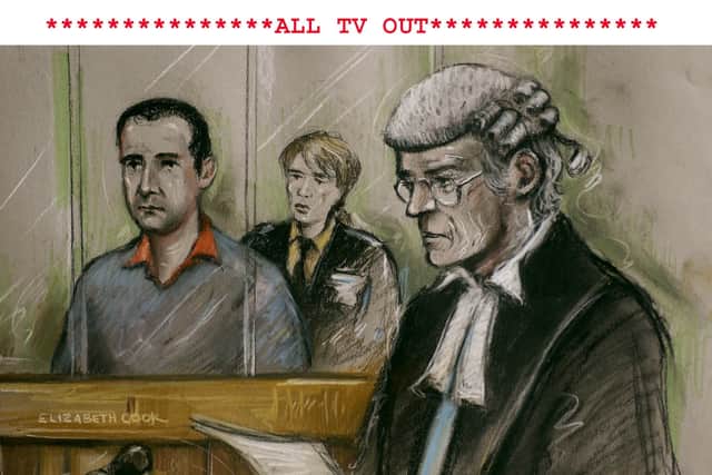 Artist's impression of Robert Hendy-Freegard, standing in the dock at Blackfriars Crown Court, in central London, facing questions from prosecuting QC Godfrey Carey, at the start of his trial in January 2004