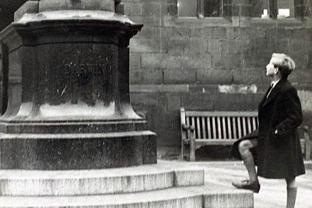 The Charles Darwin statue in Shrewsbury, pictured on February 1, 1949, being admired by John Howard Davies, who played the title role in a 1948 Oliver Twist movie.