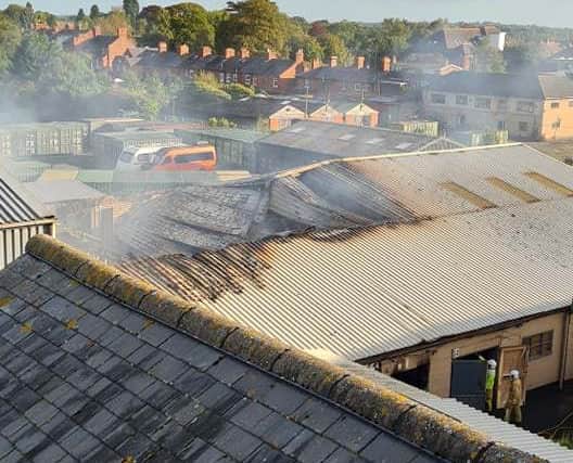 Part of the smouldering roof at Wem Business Park. photo: Si Gardner 