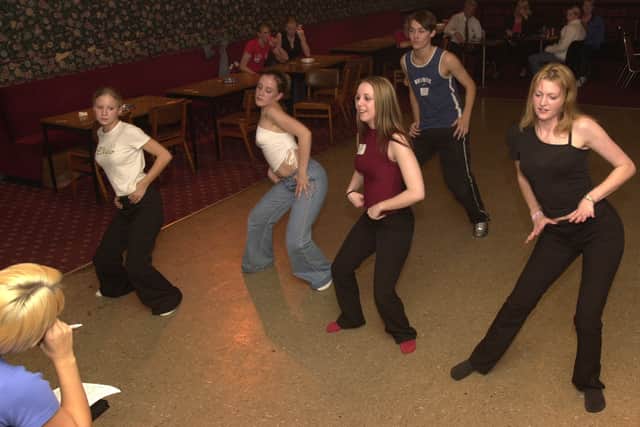 Choose me! Dancers go through their moves at the audition.
