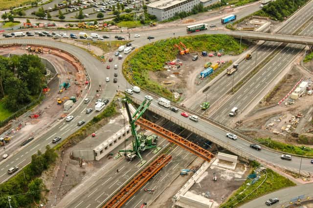 The crane lifts one of the beams into place over Junction 10 of the M6. Photo: Paul Turner