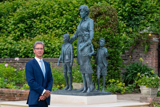 Sculptor Ian Rank-Broadley with his statue of Diana, Princess of Wales, in the Sunken Garden at Kensington Palace, London.