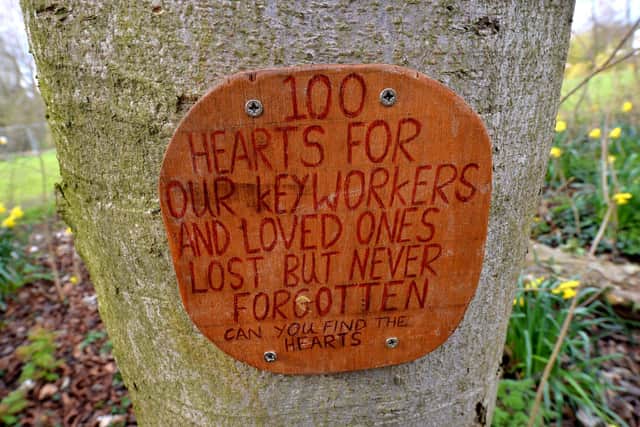 Someone has set up a trail of 100 wooden hearts