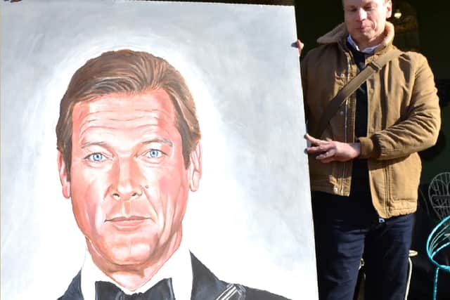 Gary Matthews with one of his large-scale portraits of Roger Moore as James Bond