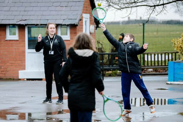 Ariana Smith teaches tennis to Benji Sambrook, aged 9, and Ellie Neves-Hill, 10, at Tilstock Primary School in Whitchurch