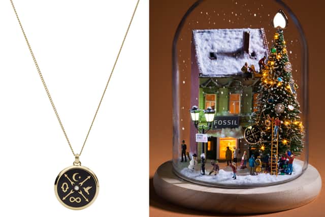 Left, the Little Fortunes Black Stainless Steel Pendant Necklace, and right, the necklace in the Fossil and Minimiam holiday snow globe scene