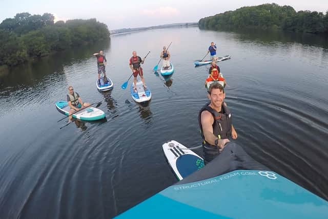 Club member Craig Jackson paddleboarding with friends