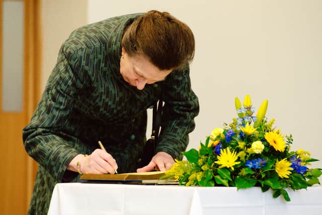Princess Anne signs the visitors' book at Harper Adams in 2018