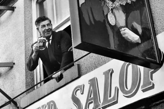 The Proud Salopian pub in Shrewsbury in January 1964, the caption reads: 'Good health from one Salopian to another this week in Shrewsbury. Mr Jack Philips, the licensee, toasted the new sign at the hotel formerly known as the Smithfield, but due to the market being transferred to Harlescott, it has been renamed the Proud Salopian. Mr Philips has been in the licensing trade for five years, and may now say that he has been the landlord of two pubs without moving from his home!'