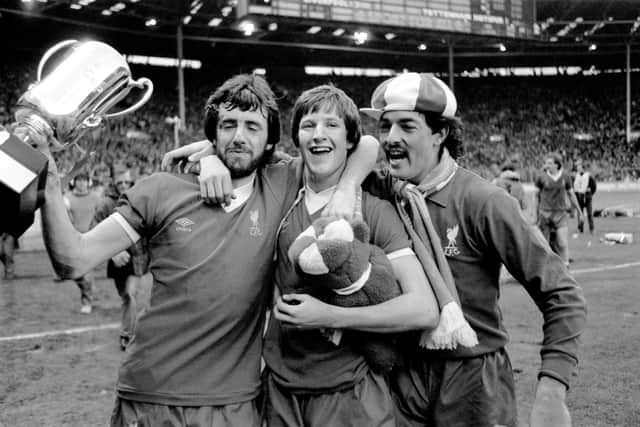 (L-R) Liverpool's Mark Lawrenson, Ronnie Whelan and Bruce Grobbelaar celebrate winning the Milk Cup.
