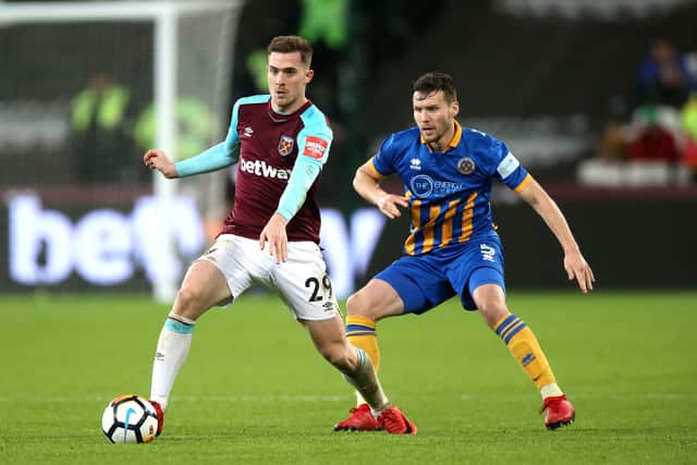 West Ham United's Toni Martinez (left) and Shrewsbury Town's Mat Sadler (right)