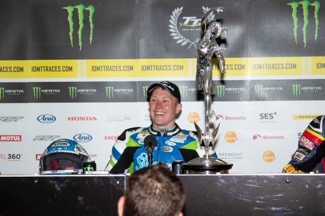 The smile says it all – Harrison with the Senior TT trophy. Picture: Ellan Vannin Images