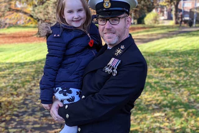 Tom Everson holding his daughter Georgia