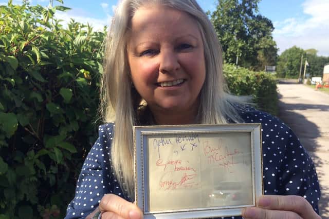 Hansons' music memorabilia specialist Claire Howell with the Beatles signatures