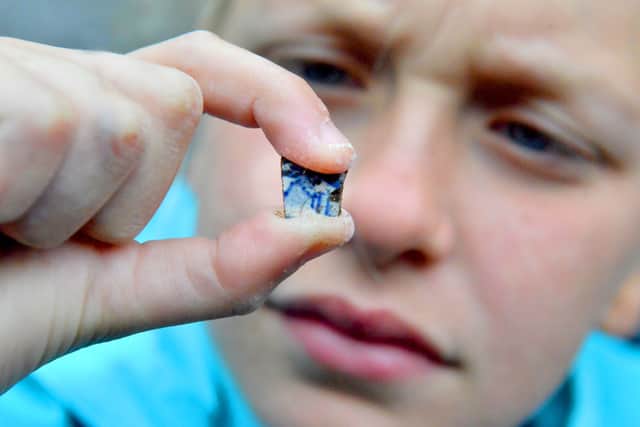 Izzy Shell with a shard of pottery